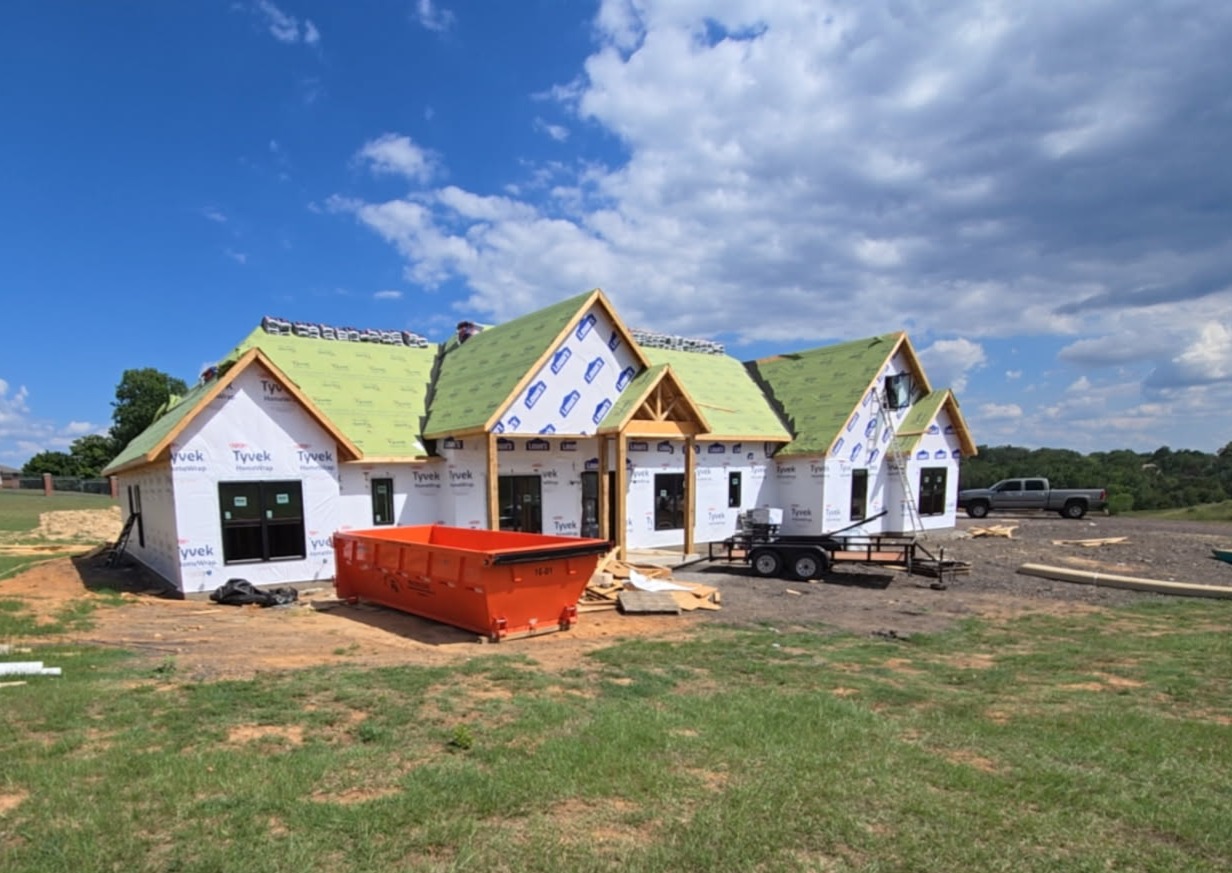 Residential dumpster rental on driveway in Van Buren AR — Kingdom Living Rolloff Services